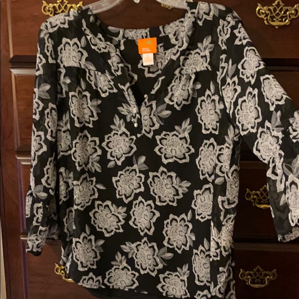 Sheer top with a black tank top attacked inside.